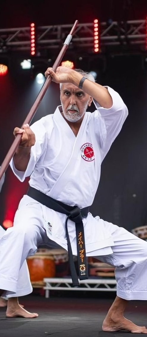 Mehar Brar demonstrating Bo kata on stage