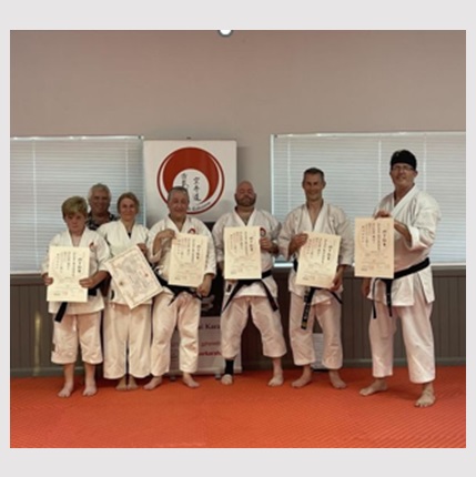 Martial artists receiving certificates